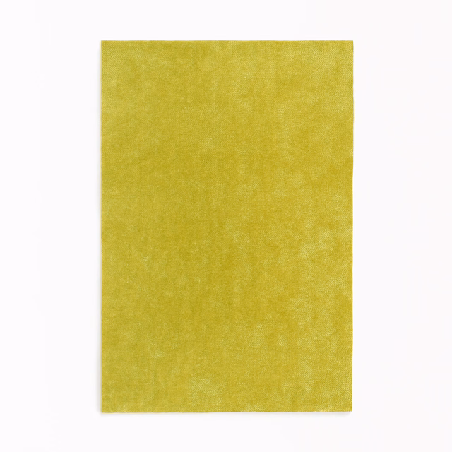Vivid absinthe-green velvet swatch with softly mottled, light-catching pile
