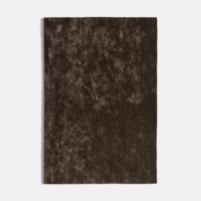 Dark antracite velvet swatch with mottled brown-charcoal pile and soft light-catching texture