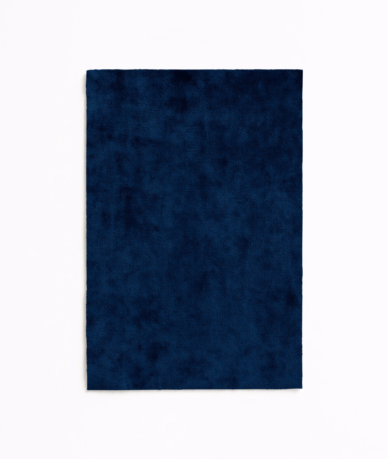 Deep Prussian-blue velvet swatch with plush, softly mottled pile and dark tonal variation
