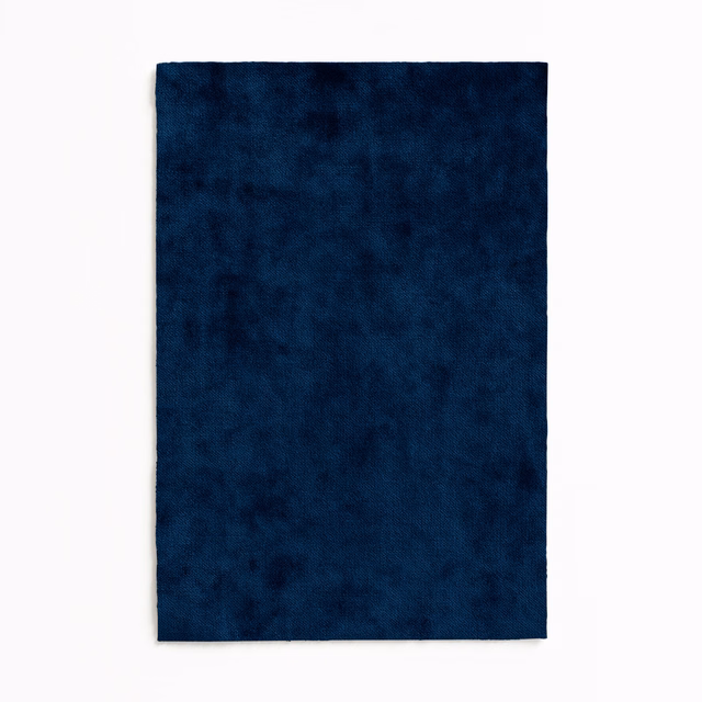 Deep Prussian-blue velvet swatch with plush, softly mottled pile and dark tonal variation