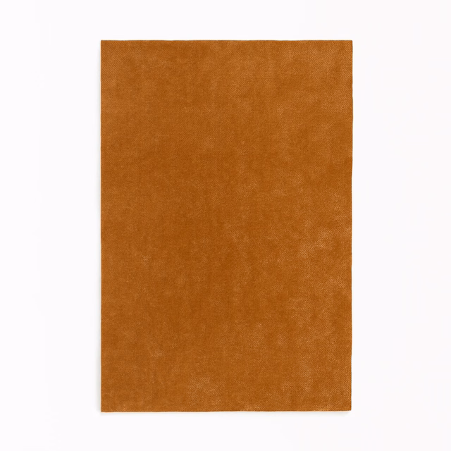 Warm cognac-brown velvet swatch with softly mottled nap and subtle tonal variation