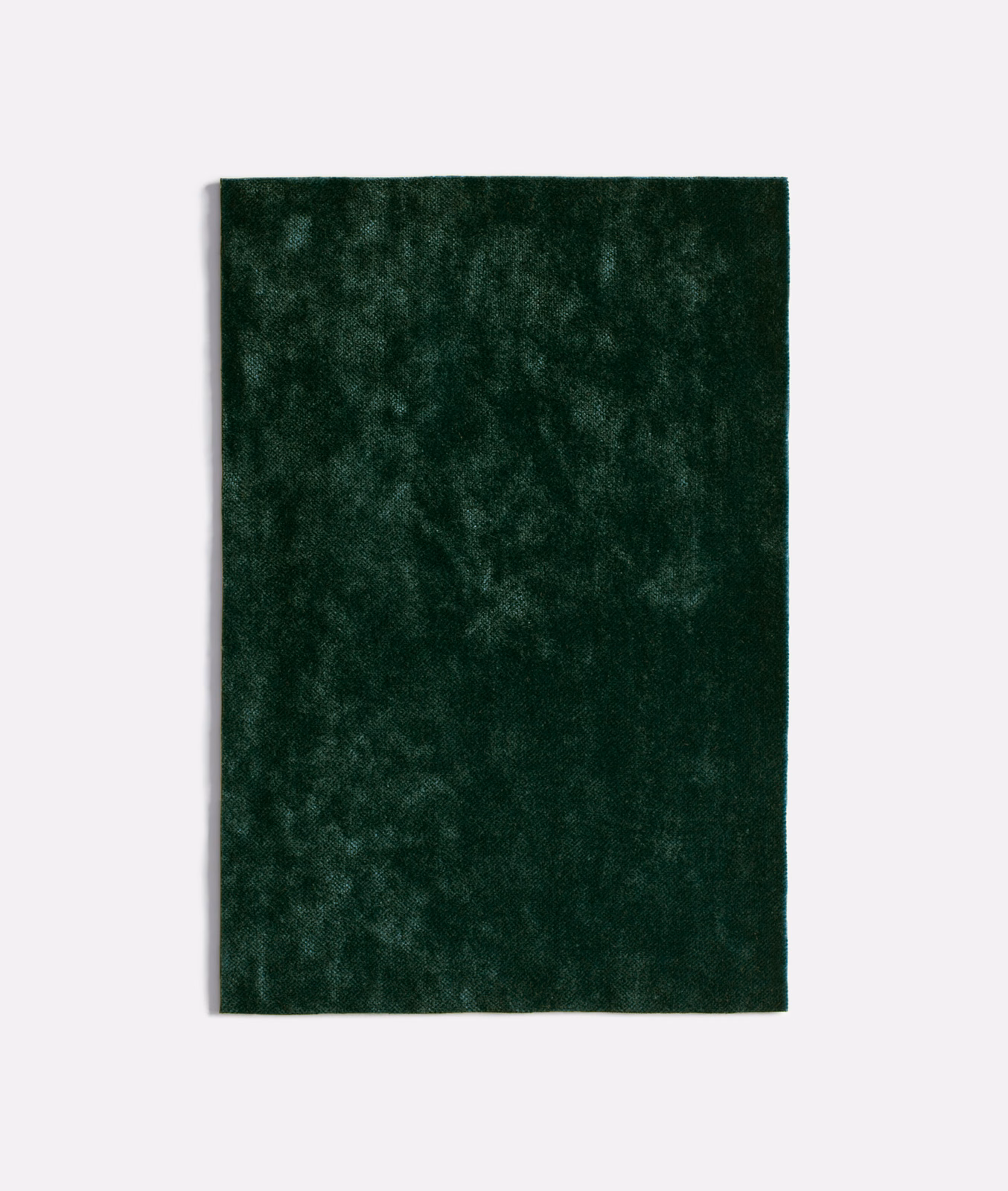 Deep forest-green velvet with softly mottled, shadowed pile texture