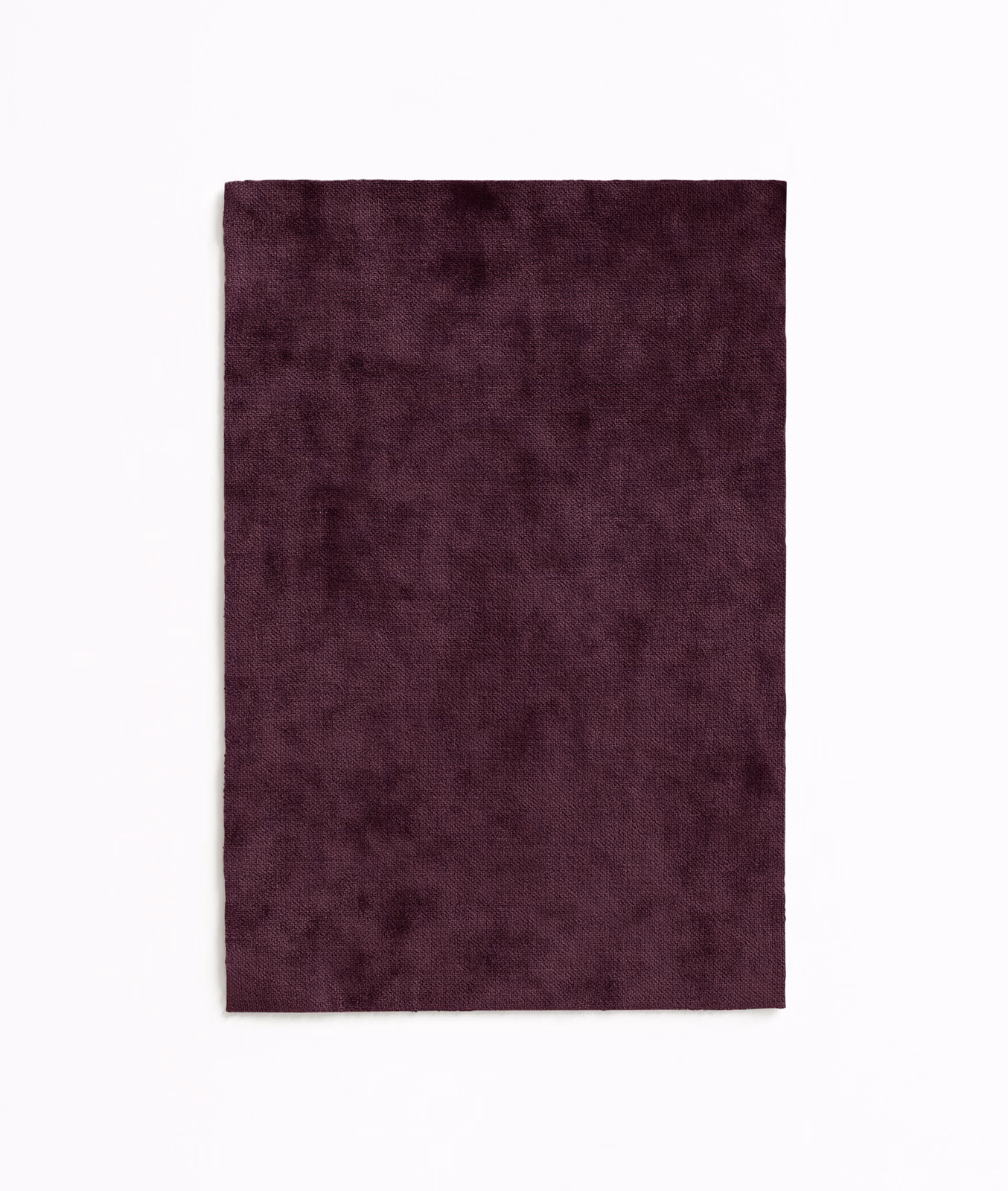 Deep plum velvet swatch with softly mottled pile and dark wine shading