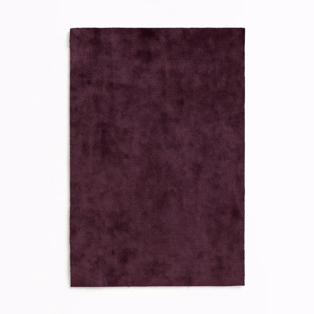 Deep plum velvet swatch with softly mottled pile and dark wine shading