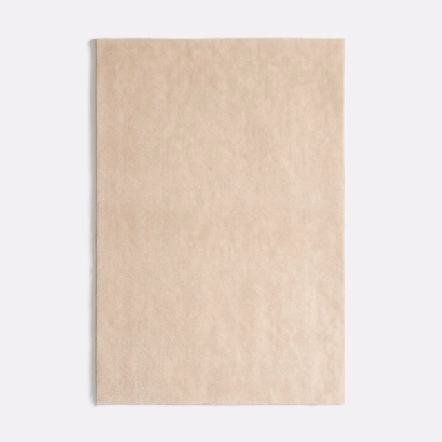 Pale warm beige velvet swatch with softly mottled plush nap and gentle light variation
