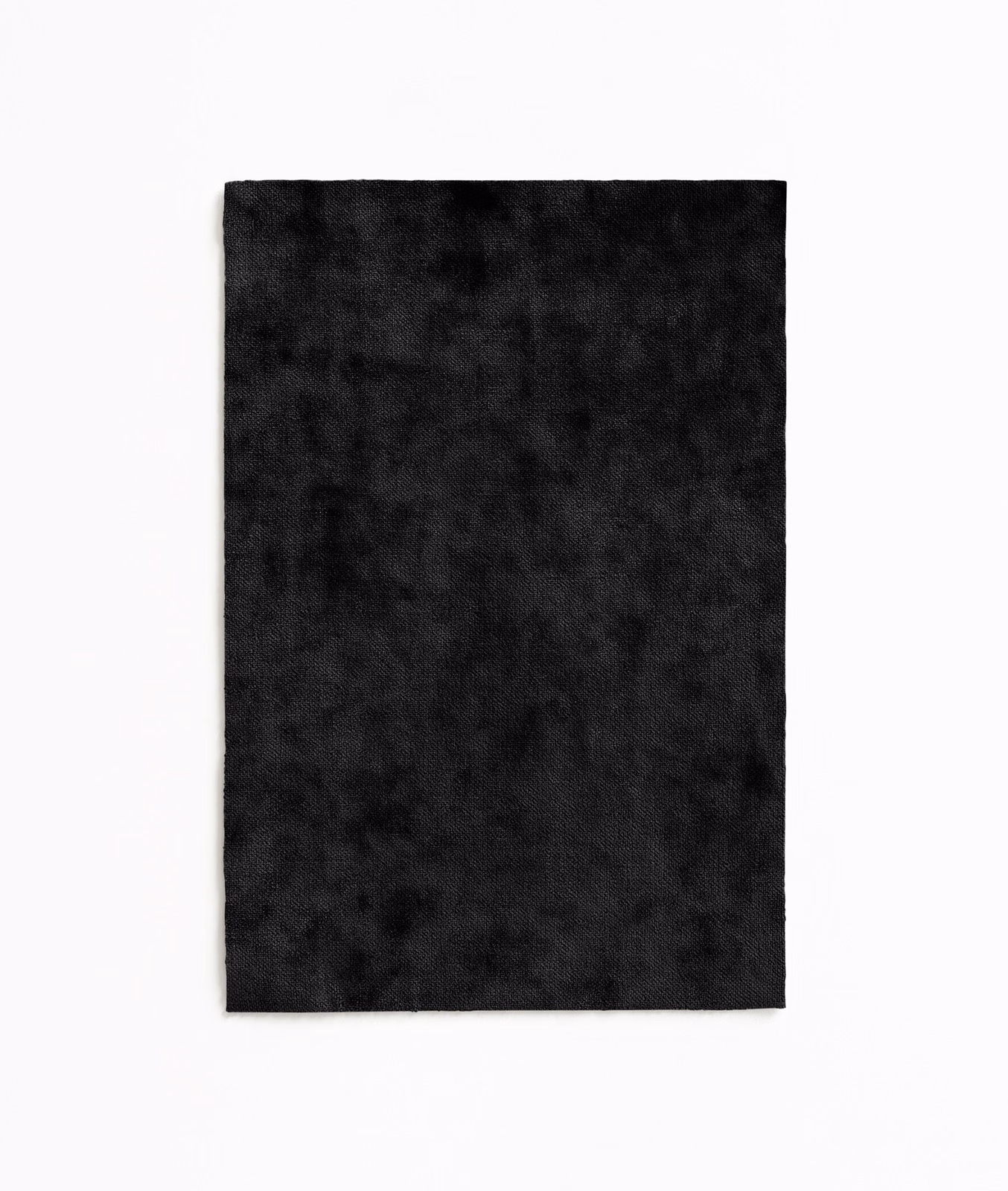Near-black velvet swatch with softly mottled charcoal pile and subtle tonal shading