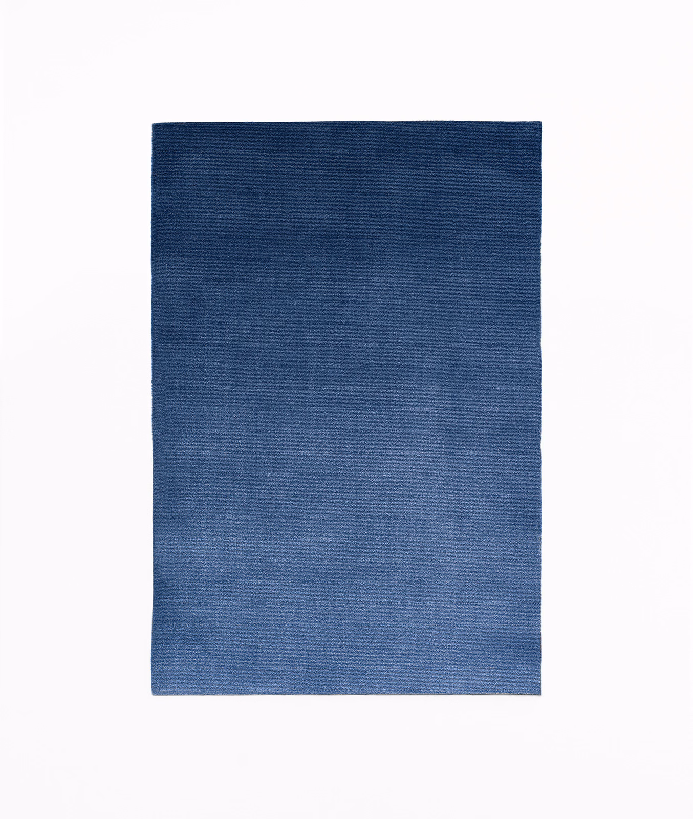Deep Prussian blue velvet swatch with softly varied pile and subtle tonal shading