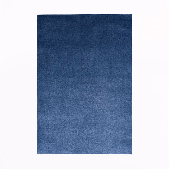 Deep Prussian blue velvet swatch with softly varied pile and subtle tonal shading