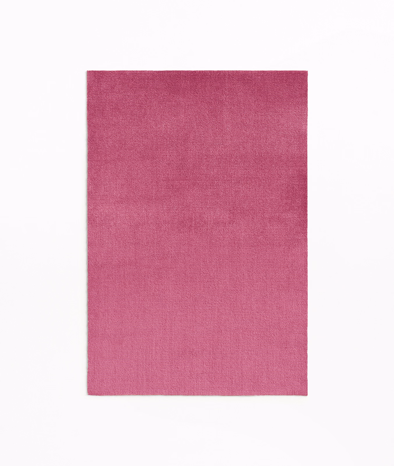 Rich magenta pink velvet swatch showing subtle directional pile and tonal surface variation