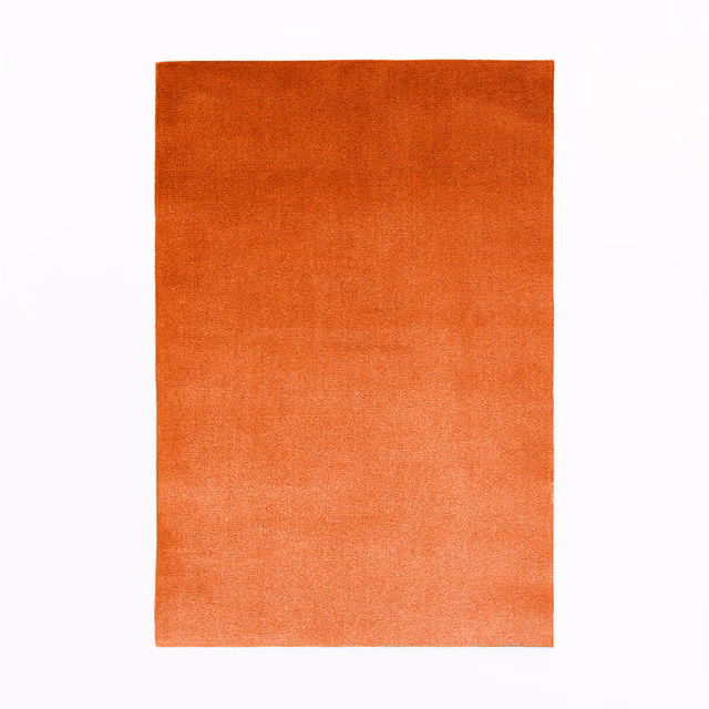 Warm burnt-orange velvet swatch with softly shifting nap and lighter coral lower edge