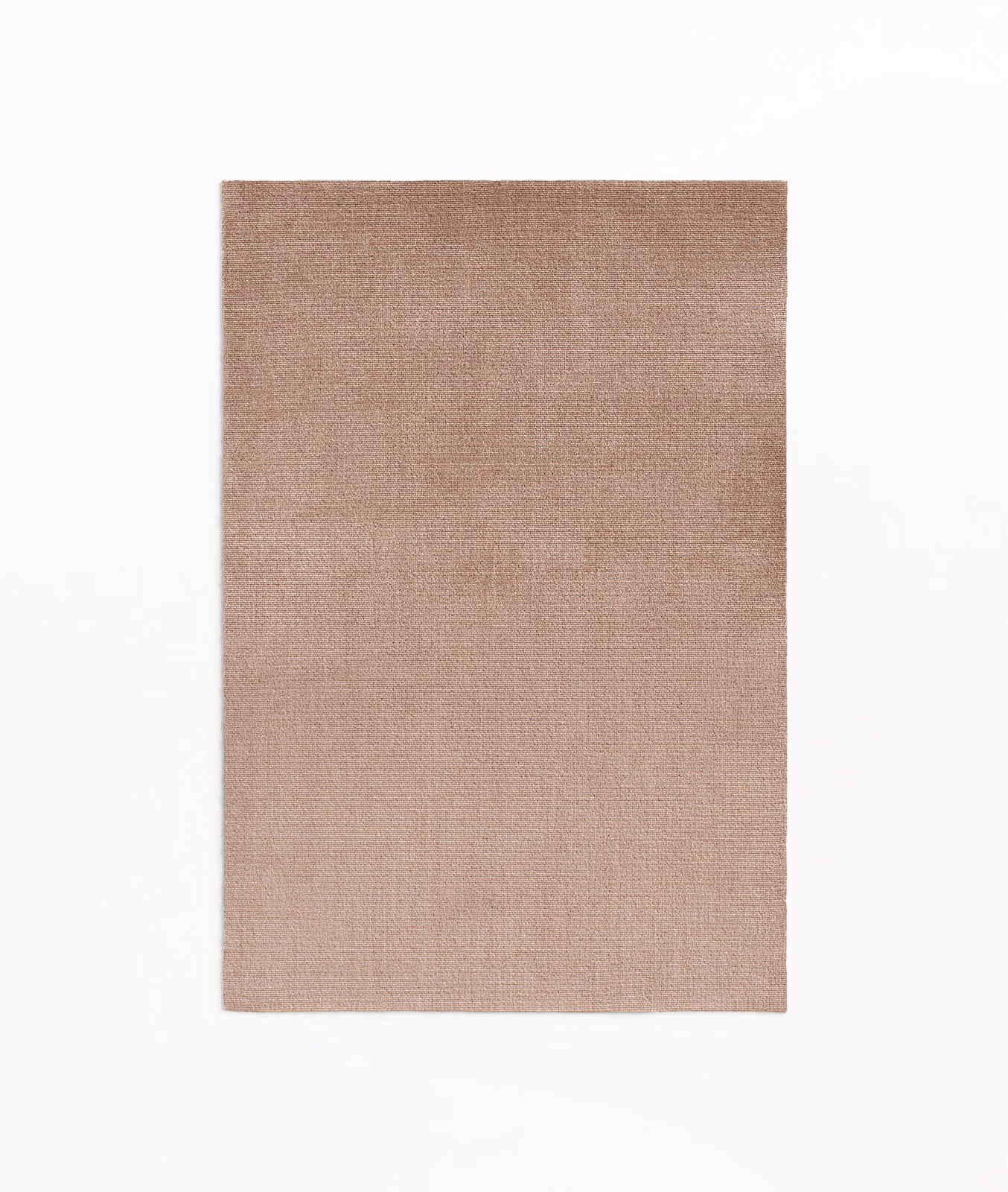 Close-up swatch of warm dusty rose velvet with subtle vertical pile shading