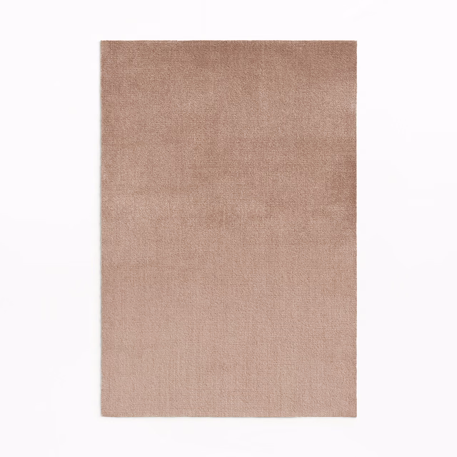 Close-up swatch of warm dusty rose velvet with subtle vertical pile shading