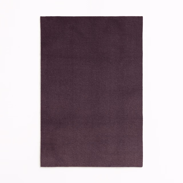 Deep aubergine velvet swatch with a fine, subtly mottled surface