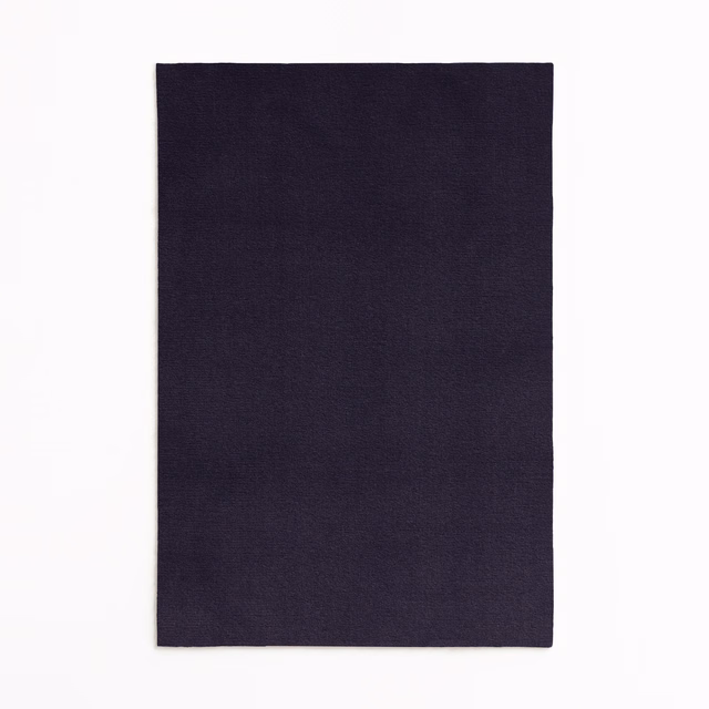 Deep ink-blue velvet swatch with subtle black shading across its plain, softly lustrous pile