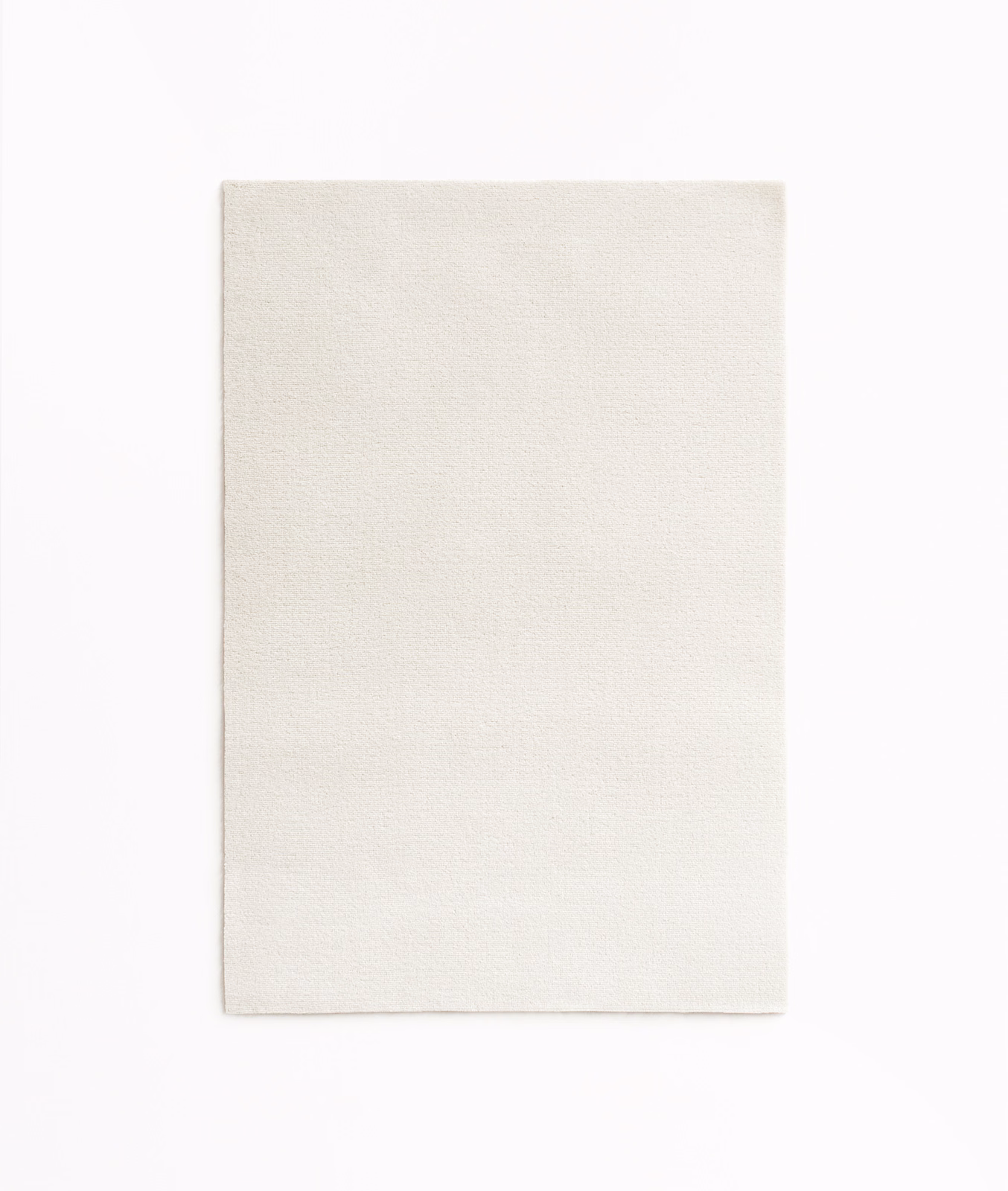 Close-up of softly textured ivory velvet with a subtle light-catching nap