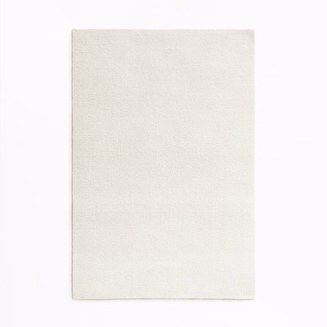 Close-up of softly textured ivory velvet with a subtle light-catching nap