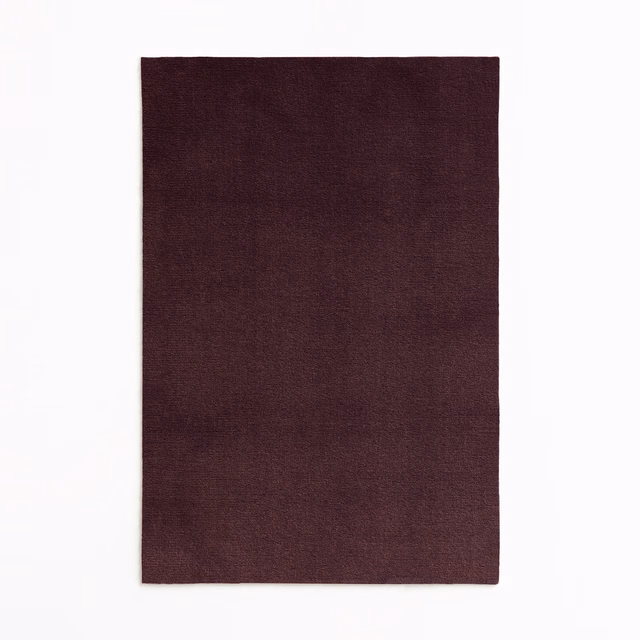 Deep plum burgundy velvet swatch with subtle directional nap and tonal shading