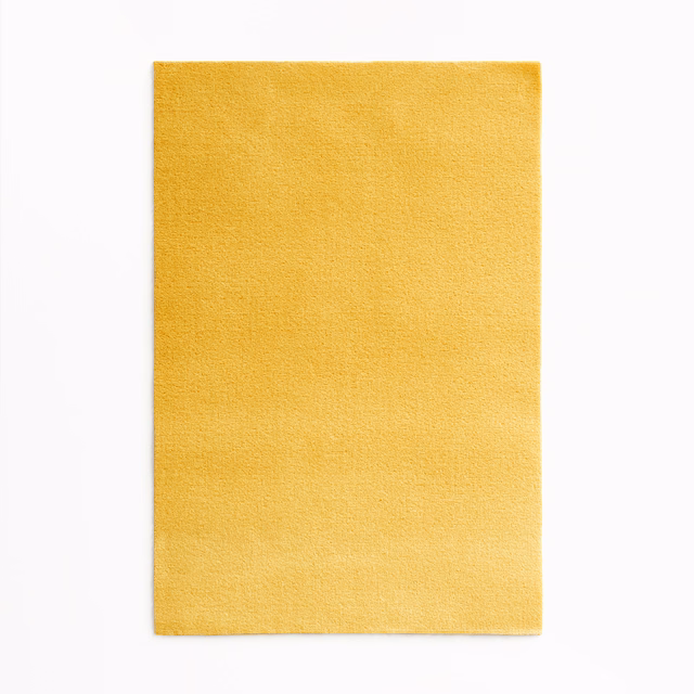 Sunflower-yellow velvet swatch with a softly brushed, subtly directional pile