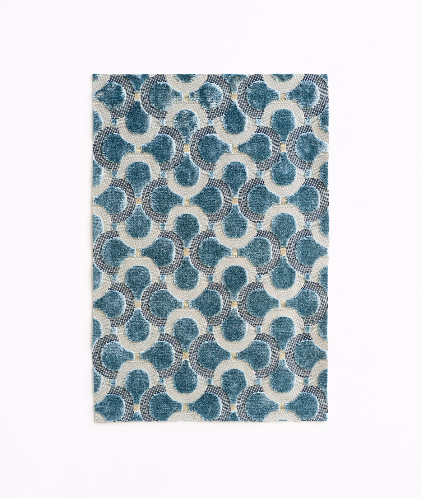 Muted teal-blue velvet with cream interlocking loops and fine ribbed texture