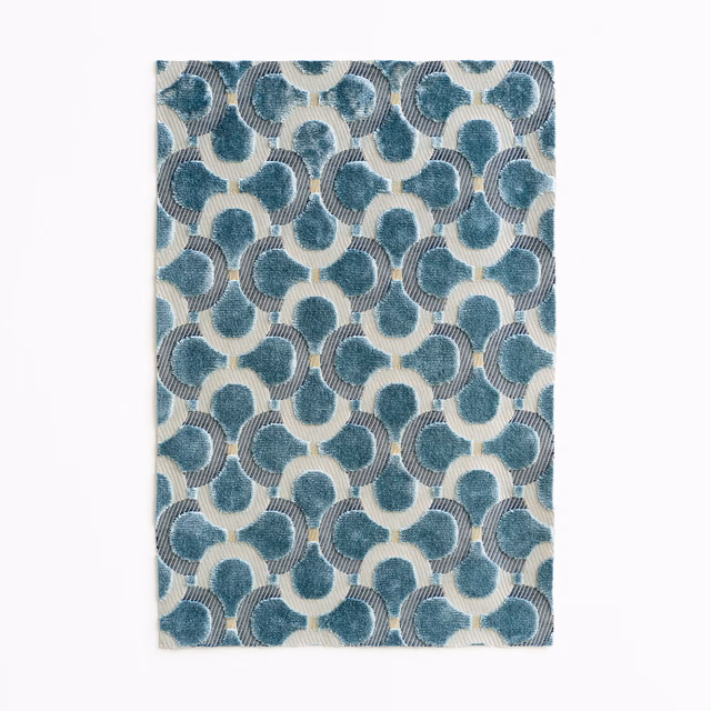 Muted teal-blue velvet with cream interlocking loops and fine ribbed texture