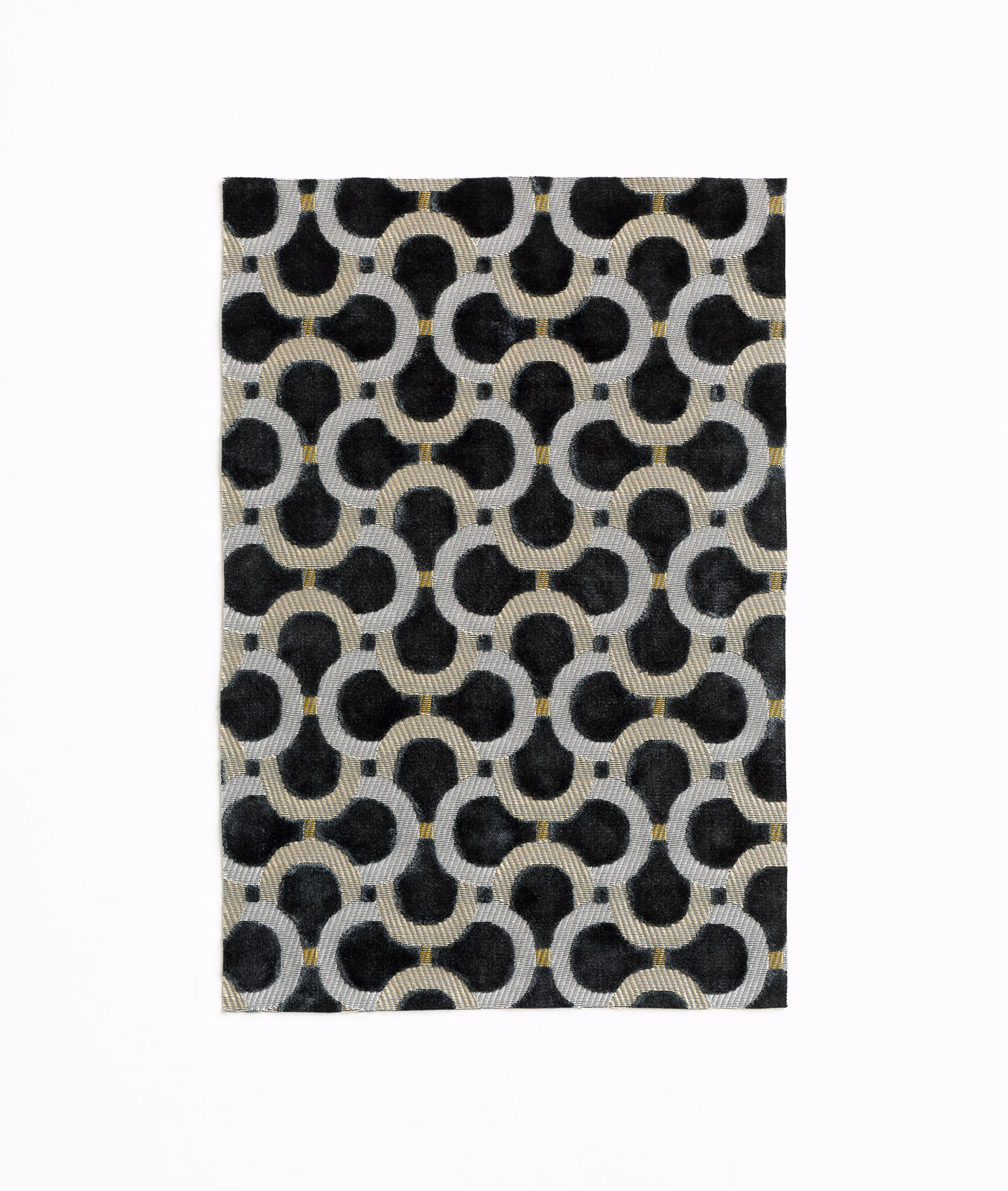 Charcoal velvet swatch with black rounded links, pale ground and tiny ochre accents