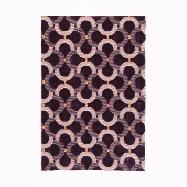 Deep plum velvet with blush interlocking arches, ribbed texture and tiny gold accents