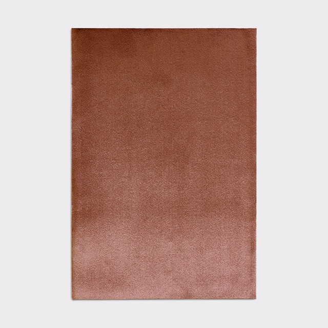 Bourbon-brown velvet swatch shifting to dusty rose with a soft directional sheen