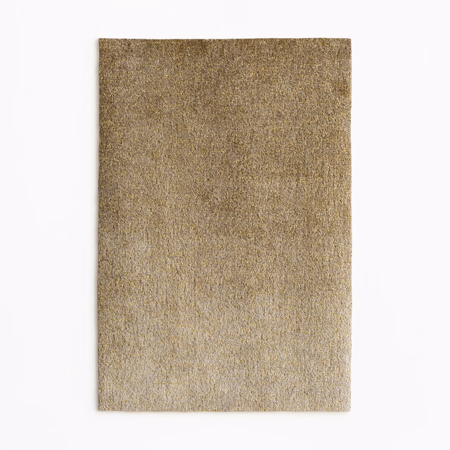 Warm taupe-gold velvet swatch with fine mottled pile and subdued sheen