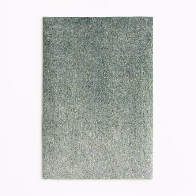 Mottled sage-grey velvet swatch with a fine, softly lustrous texture