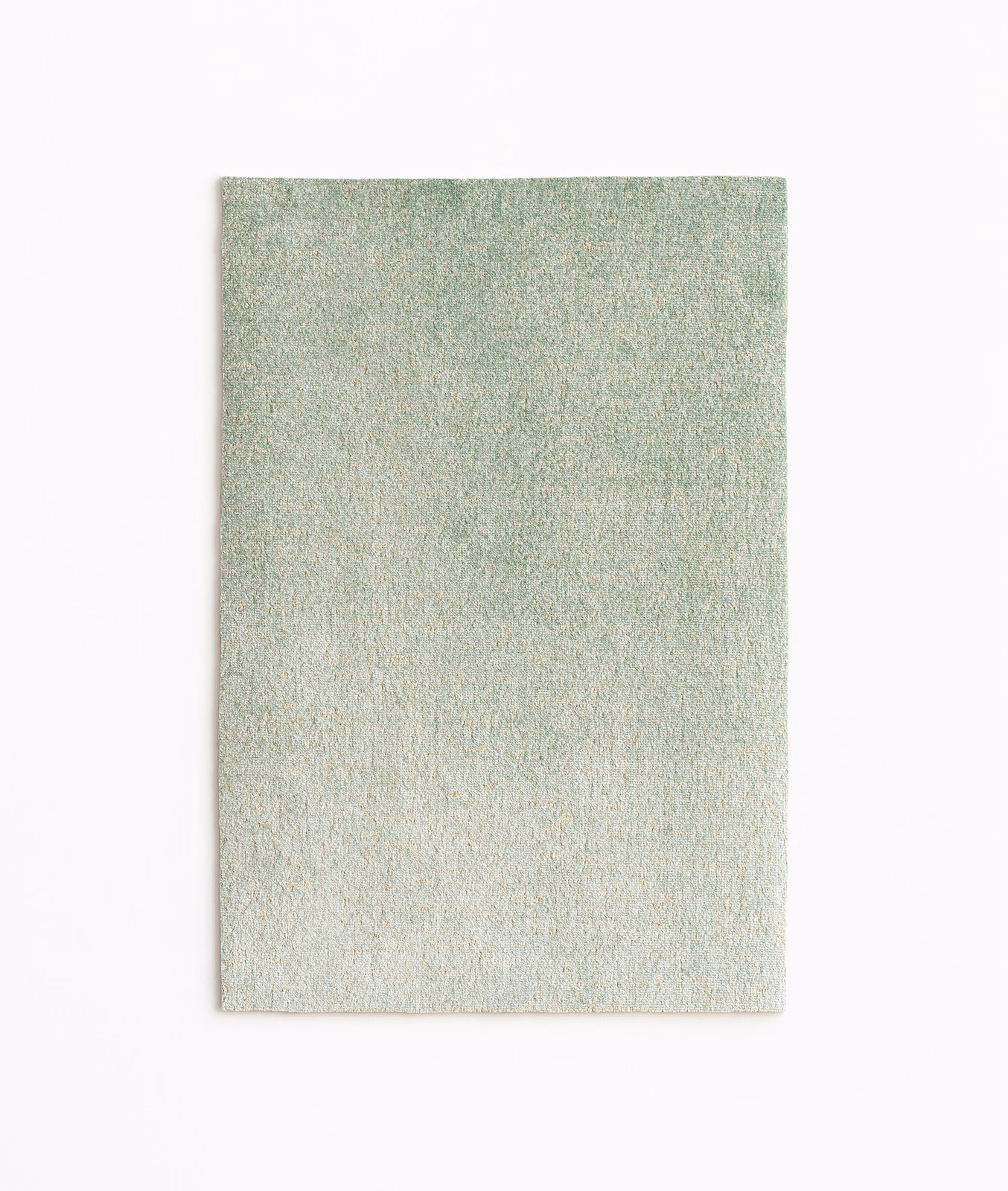 Pale sage green velvet swatch with fine mottled texture and subtle warm gold sheen