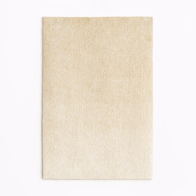 Warm ivory velvet swatch with subtle champagne-gold sheen and fine vertical texture