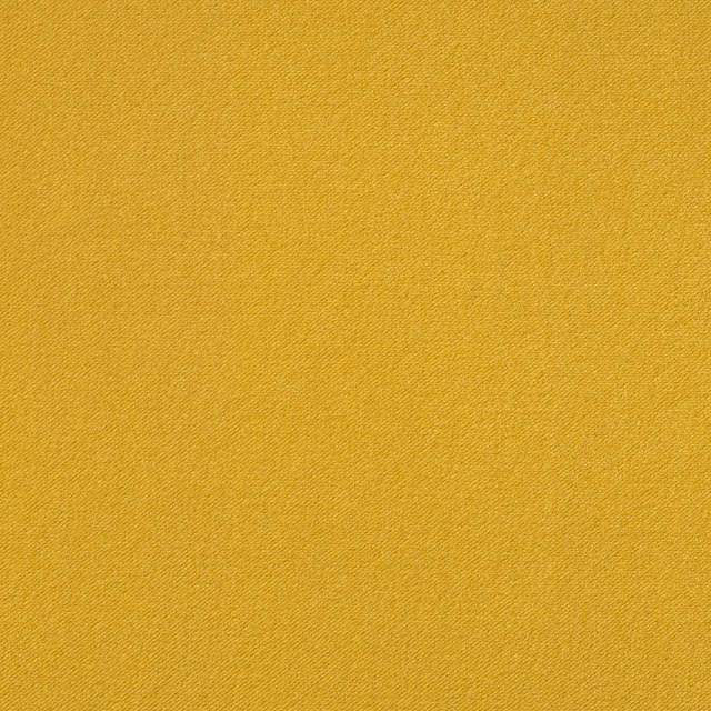 Close-up of plain saturated ochre-yellow velvet with a fine directional texture