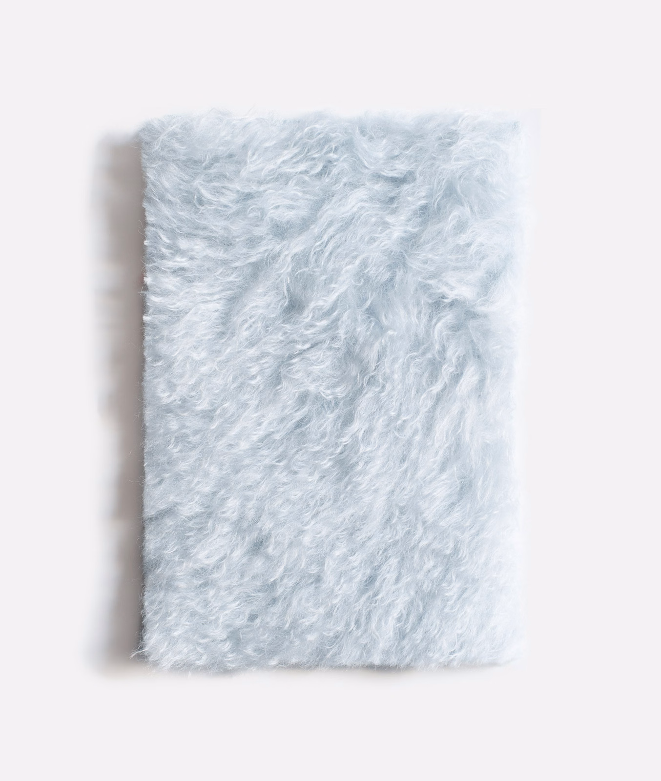 Pale icy-blue shaggy velvet swatch with curly pile and white highlights