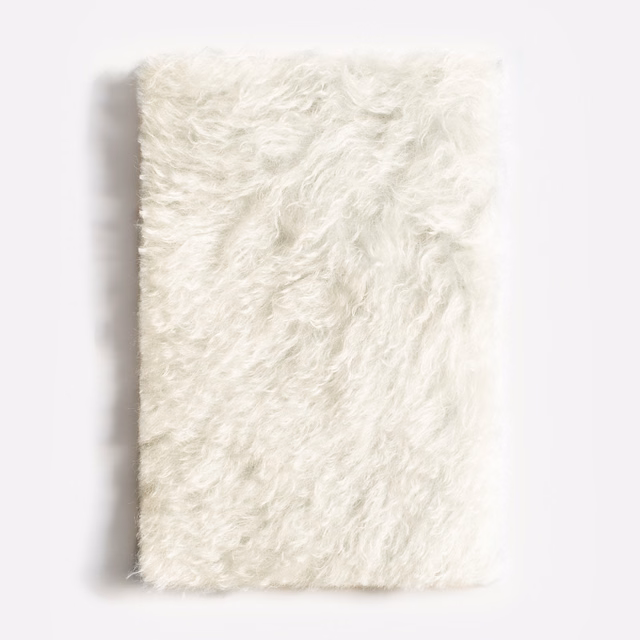 Soft ivory shaggy velvet with long tousled pile and creamy highlights