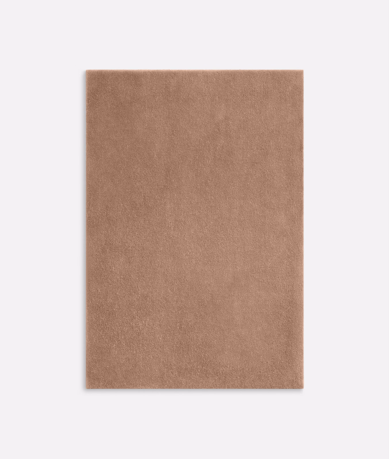 Close view of warm terracotta velvet with a softly shifting plain pile