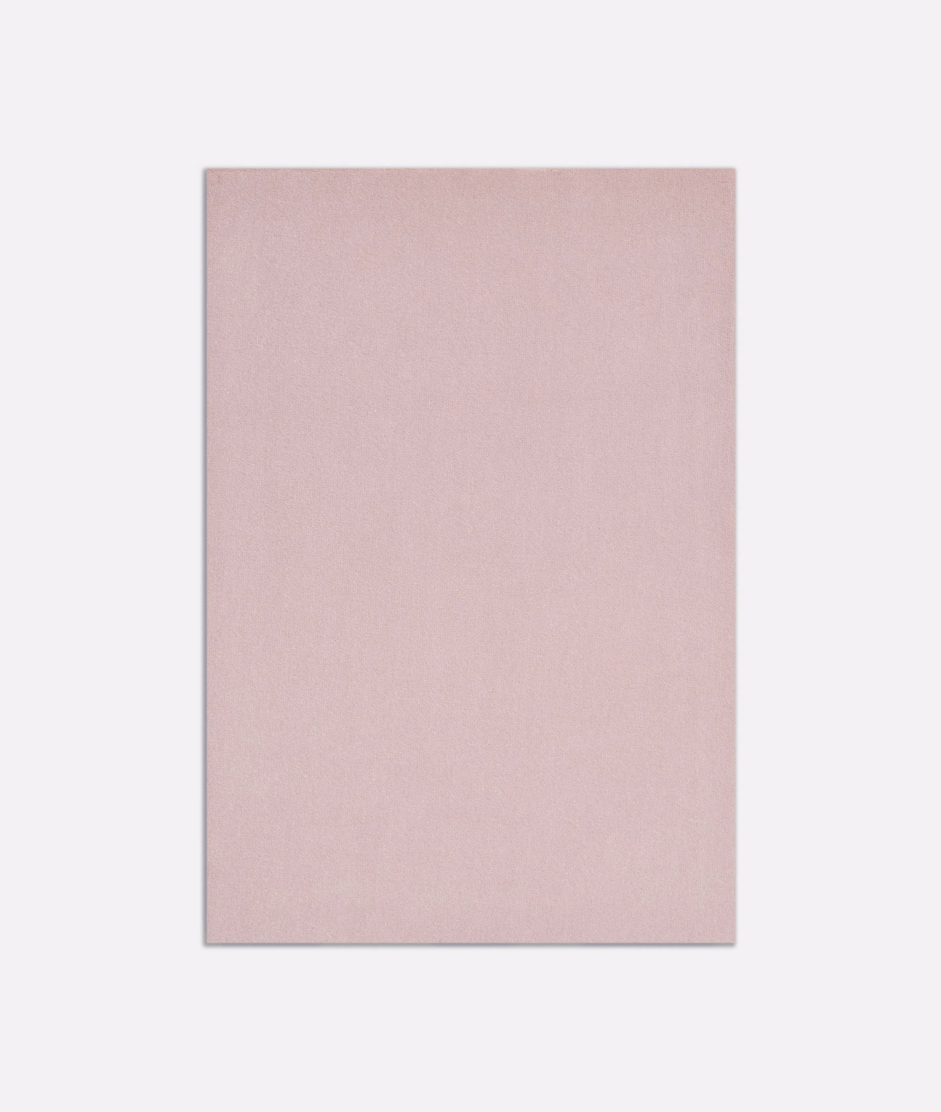 Close-up of pale dusty pink velvet with a smooth, subtly light-catching pile
