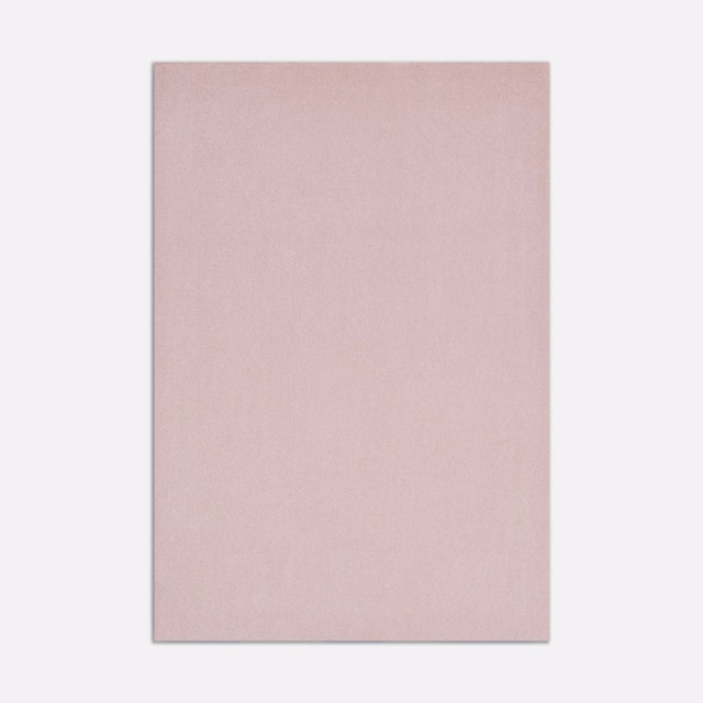 Close-up of pale dusty pink velvet with a smooth, subtly light-catching pile