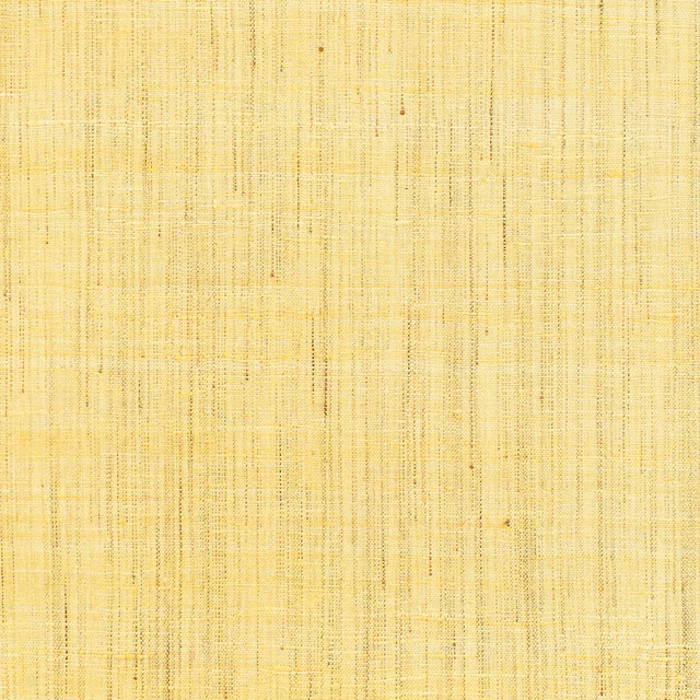 Pale sulphur-yellow wallpaper with fine crosshatched lines and tiny darker flecks