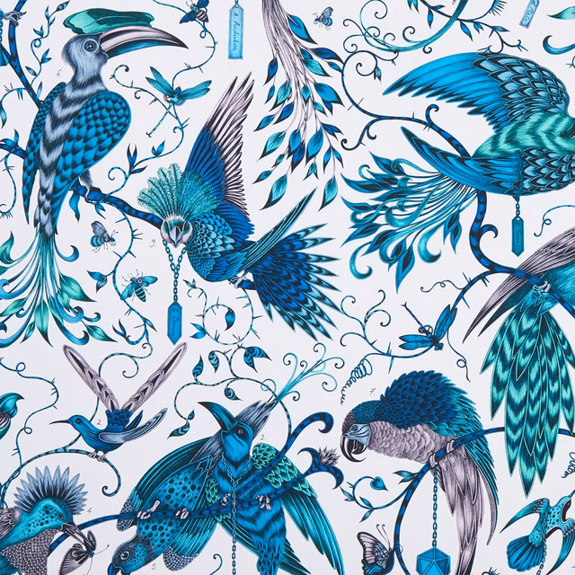White-ground textile with jewel-toned teal birds, turquoise wings and curling botanical trails