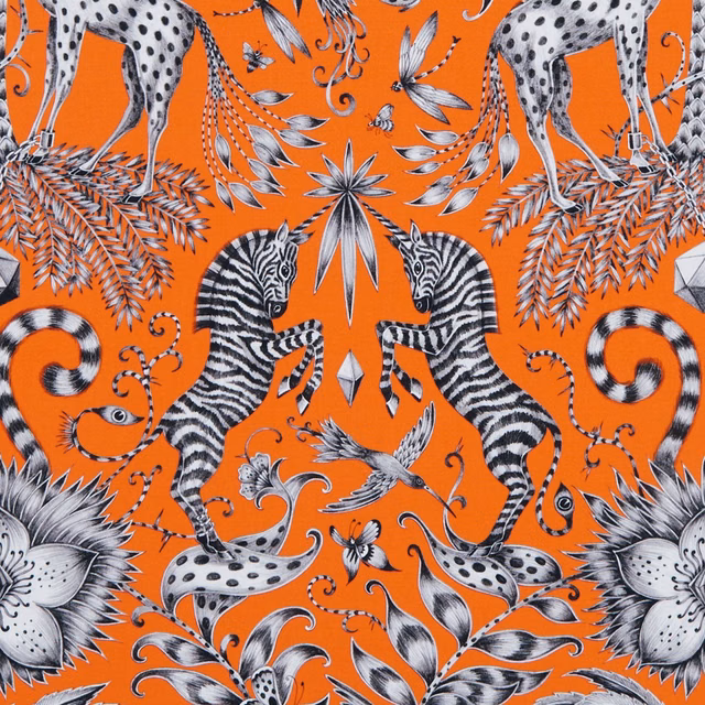 Flame-orange fabric with black-and-white zebras, giraffes, birds and botanical motifs