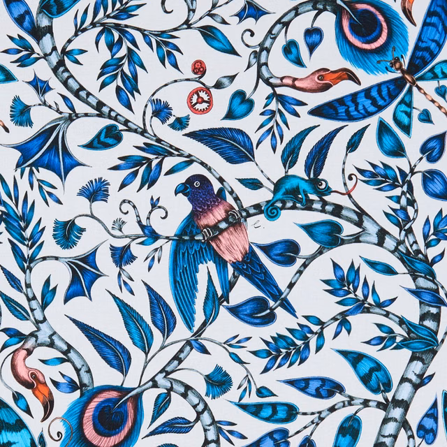 Rousseau Blue fabric with cobalt birds, teal foliage and coral accents on a pale ground