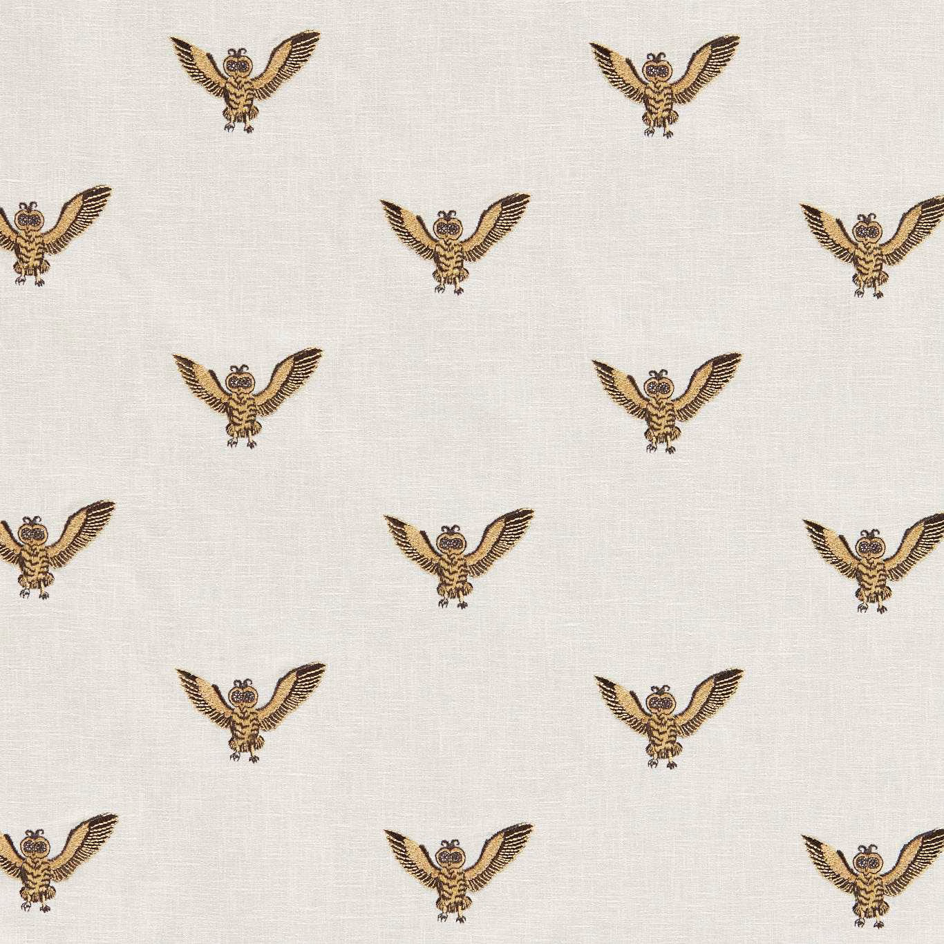 Ivory woven fabric with repeated gold-and-brown winged owl embroidery
