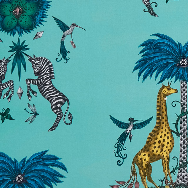 Turquoise fabric with giraffe, zebra and hummingbird motifs in jewel tones