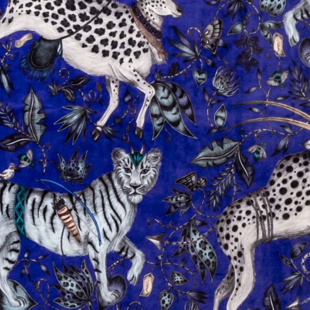 Cobalt velvet showing white leopards, striped zebra, insects and botanical motifs