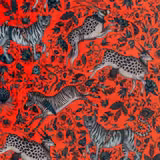 Vivid coral velvet with charcoal wildlife, striped zebra and spotted antelope motifs