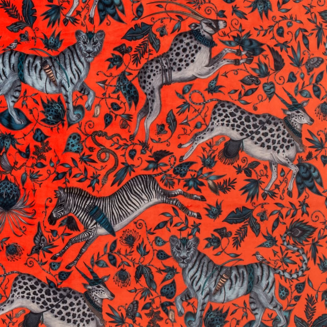 Vivid coral velvet with charcoal wildlife, striped zebra and spotted antelope motifs