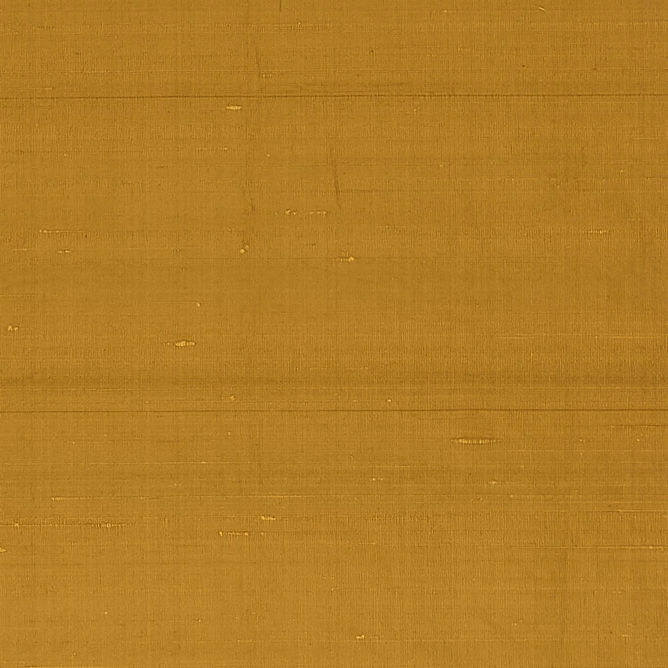 Warm amber plain weave with fine slubs and scattered lighter flecks