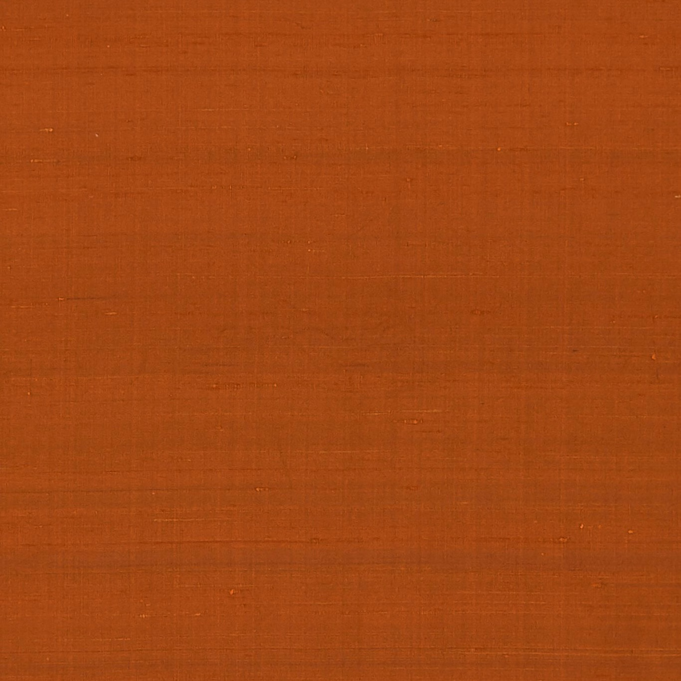 Burnt terracotta orange fabric with a subtle fine crosshatched woven texture
