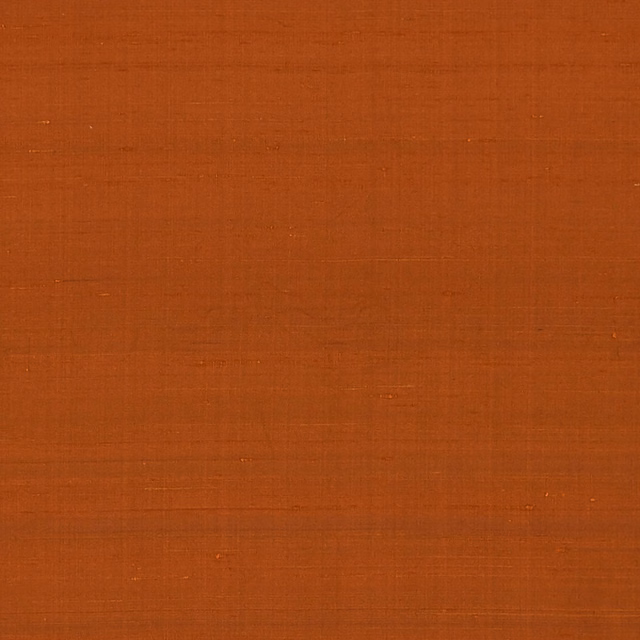 Burnt terracotta orange fabric with a subtle fine crosshatched woven texture