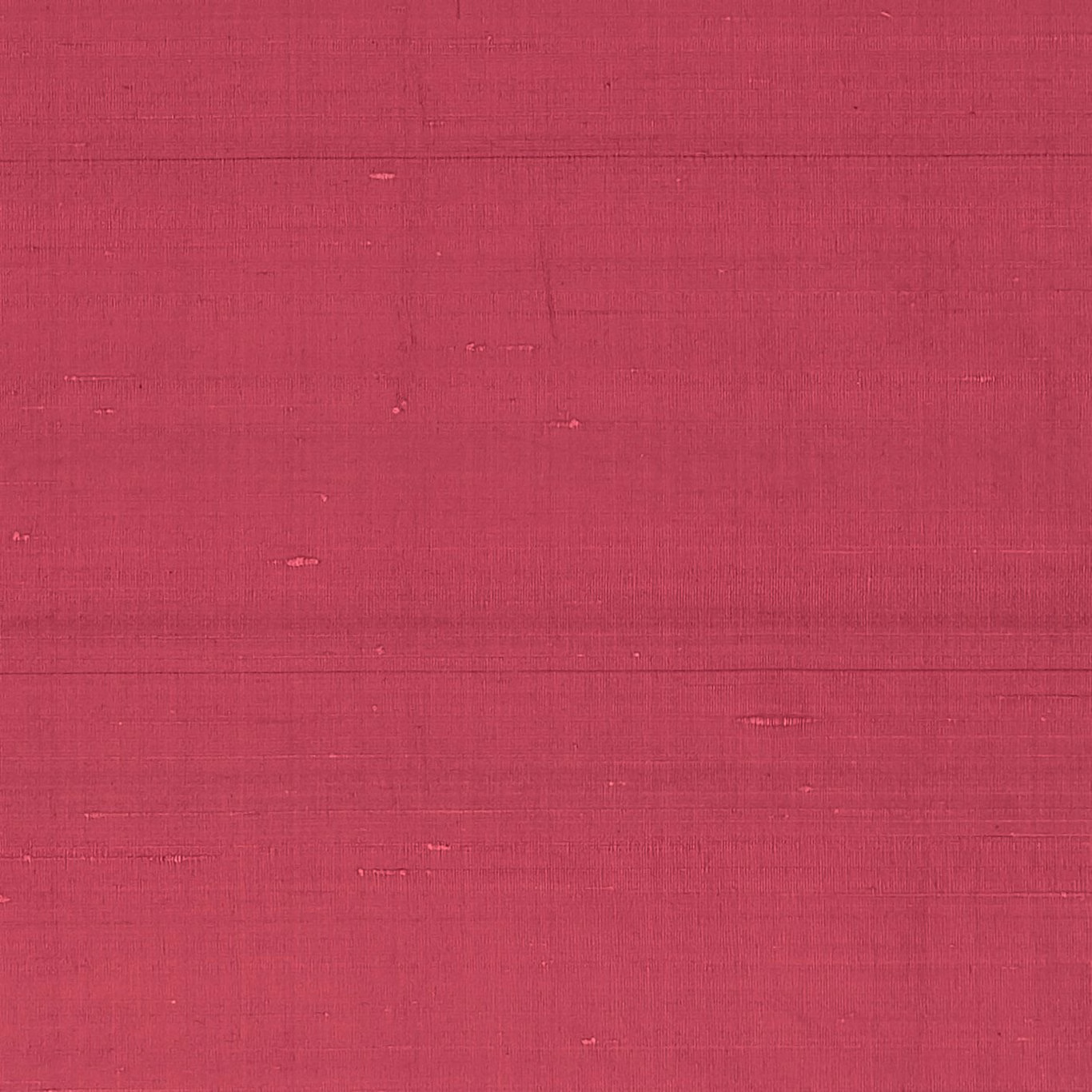 Close view of deep cardinal-red textile with fine horizontal slubs and woven grain